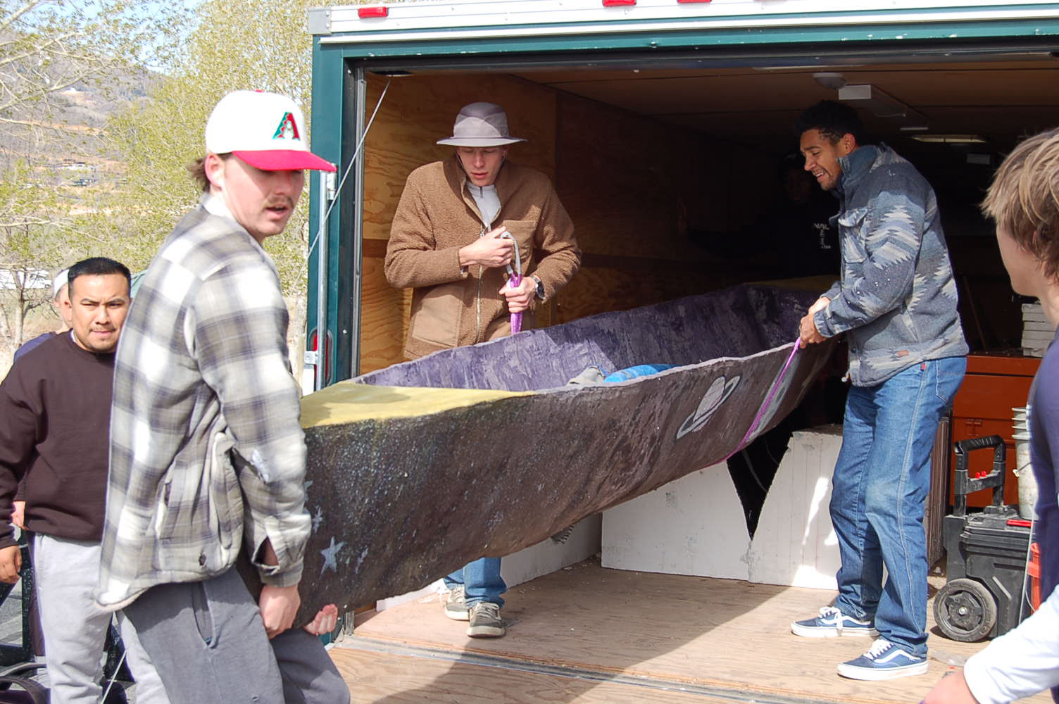 Team unloading canoe from trailer